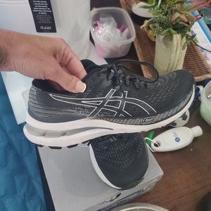 Black and white Asic running shoes